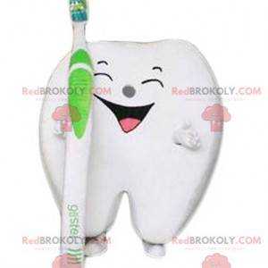 Mascotte de dent blanche rieuse géante avec une brosse à dents