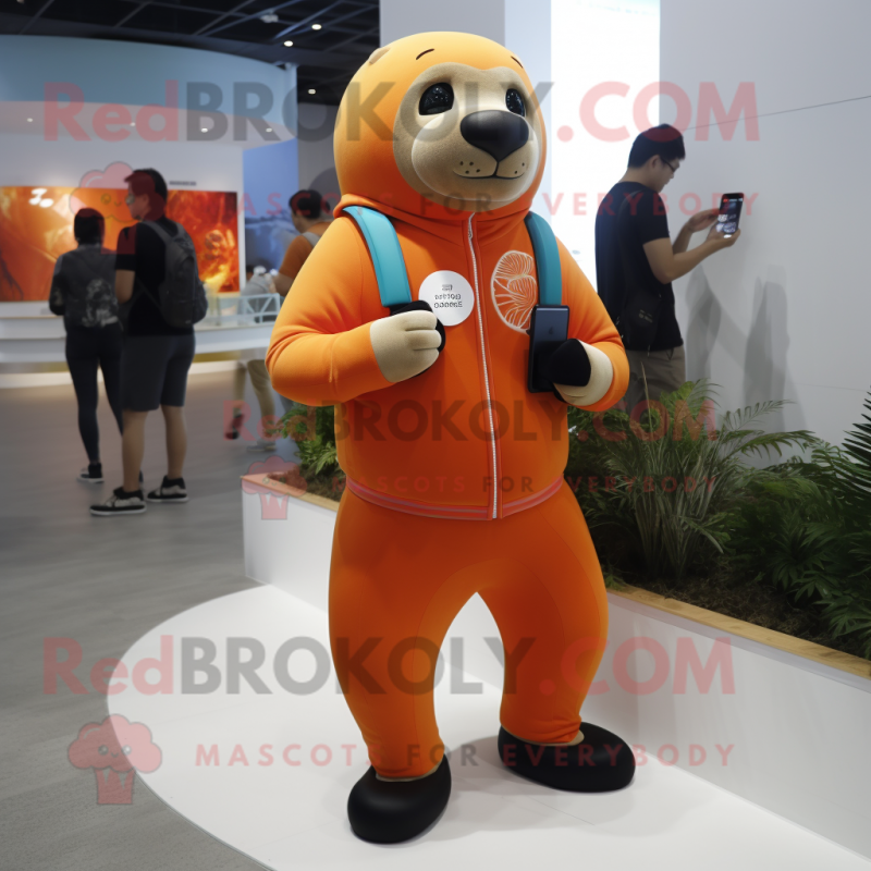 Orange Sea Lion mascot costume character dressed with a Joggers and Smartwatches