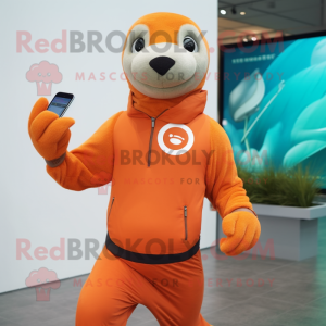 Orange Sea Lion mascot costume character dressed with a Joggers and Smartwatches