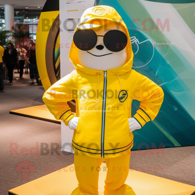 Yellow Plate Spinner mascot costume character dressed with a Windbreaker and Sunglasses Yellow Plate Spinner mascot costume character dressed with a Windbreaker and Sunglasses