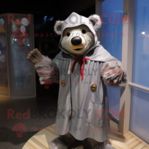 Gray Bear mascot costume character dressed with a Raincoat and Shawl pins
