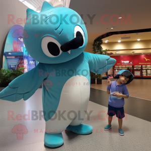 Turquoise Manta Ray mascot costume character dressed with a Chinos and Bracelets