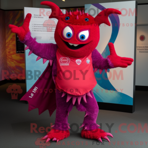 Maskotfigur af en magenta...