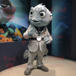 Gray Goldfish mascot costume character dressed with a Blazer and Smartwatches