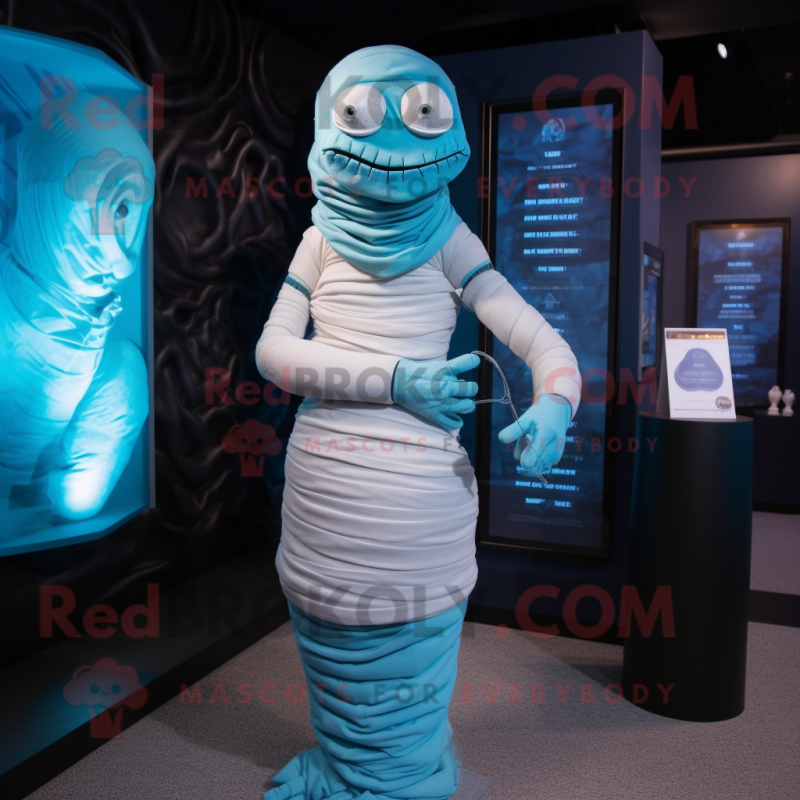 Cyan Mummy mascot costume character dressed with a Cocktail Dress and Shawl pins