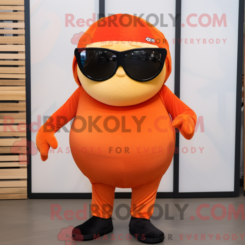 Mascot character of a Orange Shakshuka dressed with a V-Neck Tee and Sunglasses Mascot character of a Orange Shakshuka dressed with a V-Neck Tee and Sunglasses