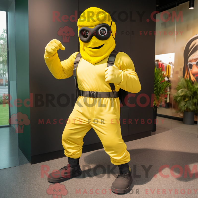 Mascot character of a Yellow Commando dressed with a Joggers and Rings Mascot character of a Yellow Commando dressed with a Joggers and Rings