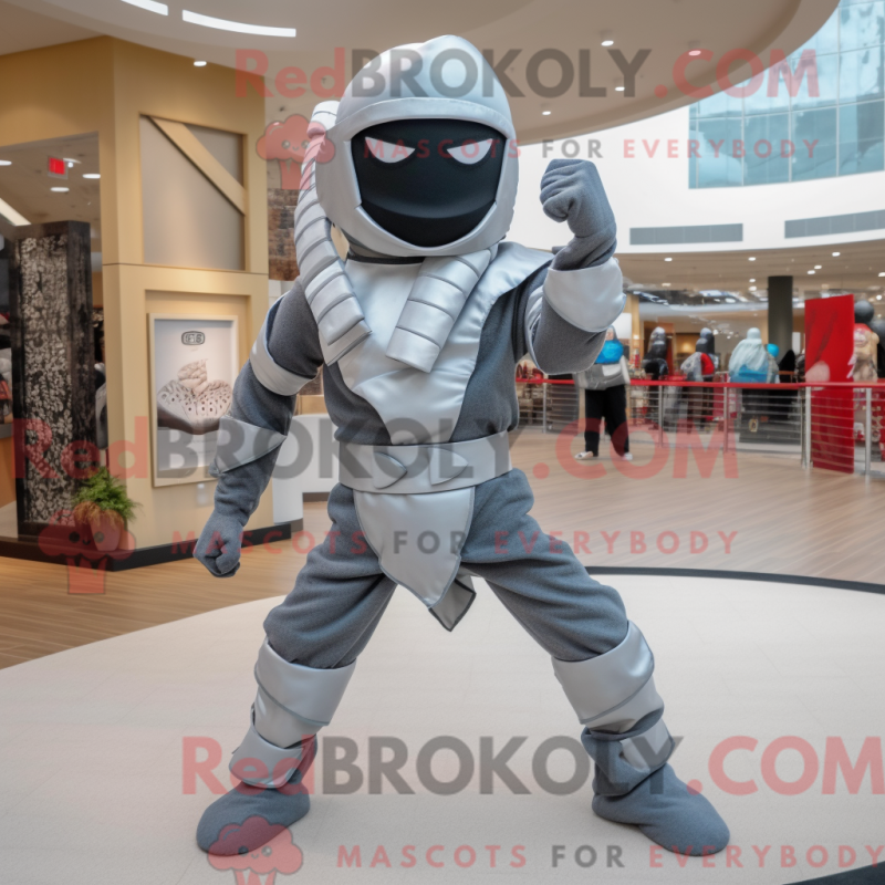 Mascot character of a Silver Ninja dressed with a Flare Jeans and Ties Mascot character of a Silver Ninja dressed with a Flare Jeans and Ties