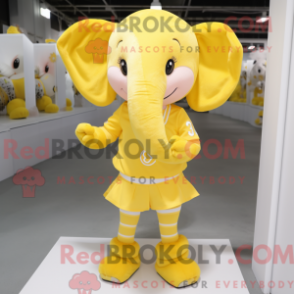 Mascot character of a Yellow Elephant dressed with a Mini Skirt and Headbands