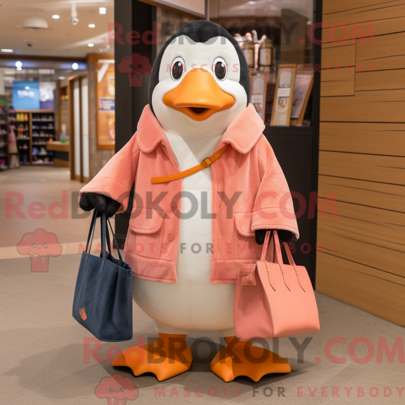 Mascot character of a Peach Penguin dressed with a Coat and Tote bags Mascot character of a Peach Penguin dressed with a Coat and Tote bags