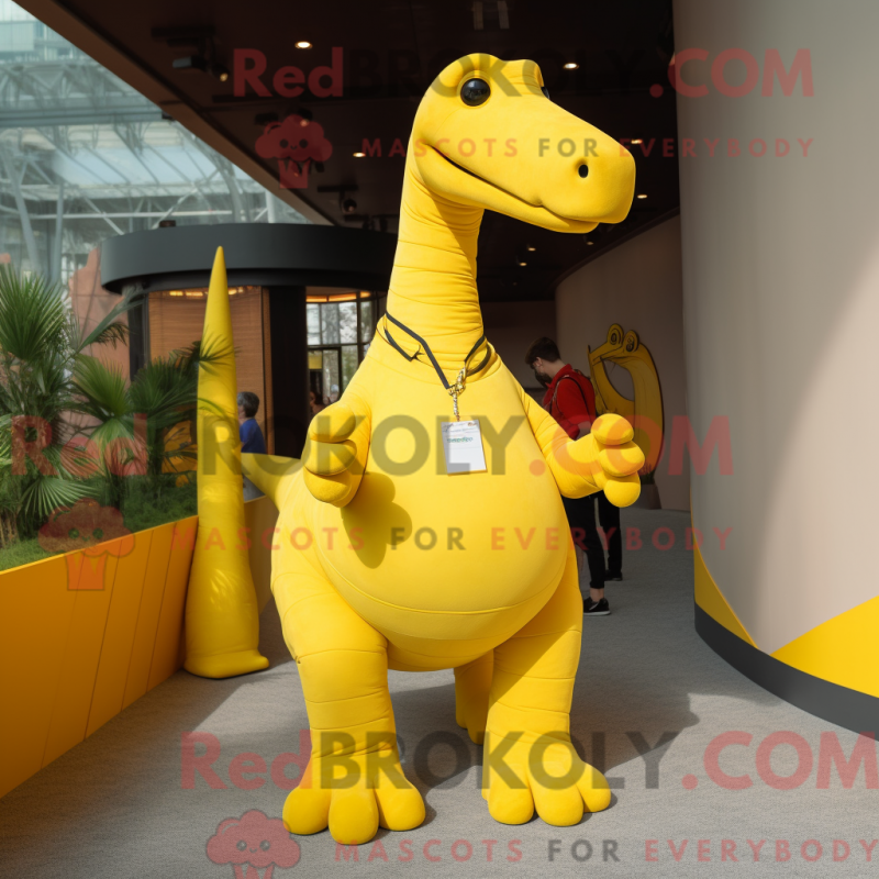 Mascot character of a Yellow Brachiosaurus dressed with a Polo Tee and Suspenders Mascot character of a Yellow Brachiosaurus dressed with a Polo Tee and Suspenders