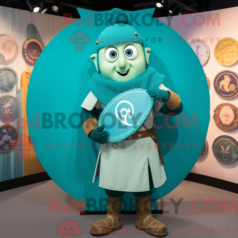 Mascot character of a Turquoise Celtic Shield dressed with a Henley Tee and Caps Mascot character of a Turquoise Celtic Shield dressed with a Henley Tee and Caps