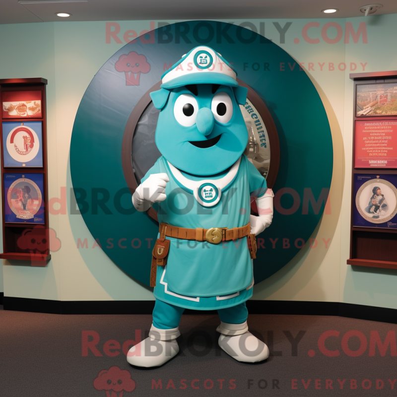 Mascot character of a Turquoise Celtic Shield dressed with a Henley Tee and Caps Mascot character of a Turquoise Celtic Shield dressed with a Henley Tee and Caps