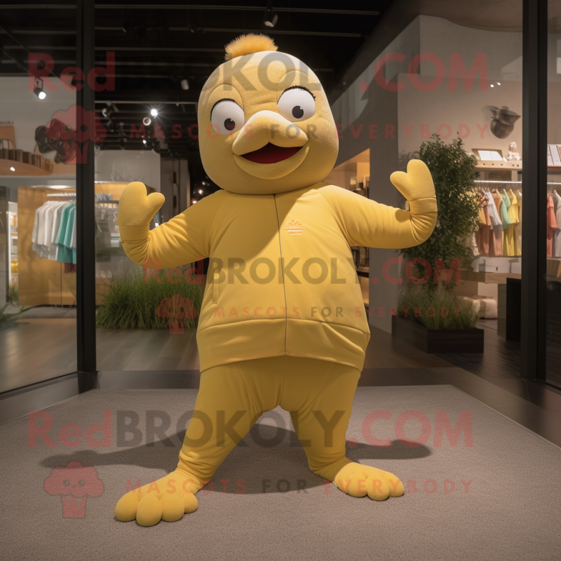 Tan Canary mascot costume character dressed with a Yoga Pants and Gloves Tan Canary mascot costume character dressed with a Yoga Pants and Gloves