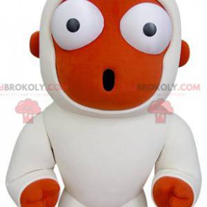 Mascota mono naranja y blanco mirando sorprendido -