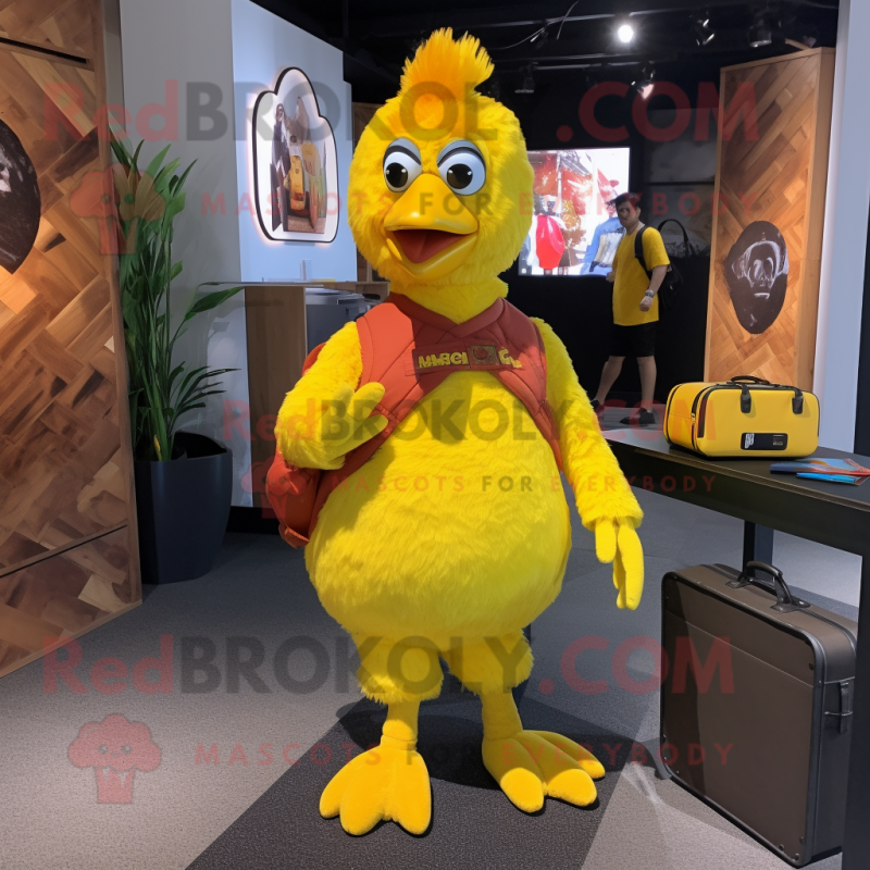 Yellow Chicken mascot costume character dressed with a Jumpsuit and Messenger bags