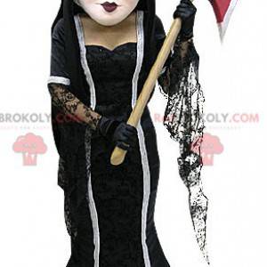 Mascote da bruxa marrom em um vestido com um machado -