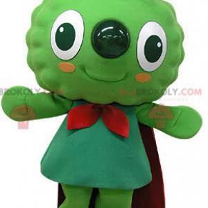 Mascote do boneco de neve verde muito sorridente com uma capa -