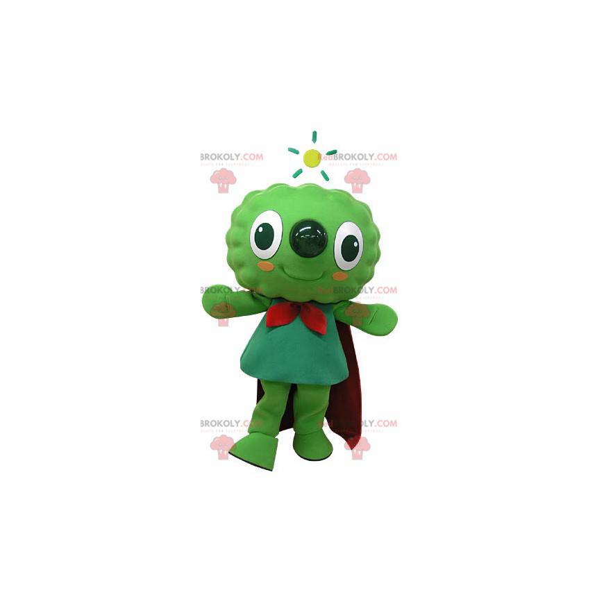 Mascote do boneco de neve verde muito sorridente com uma capa -