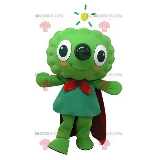 Mascote do boneco de neve verde muito sorridente com uma capa -