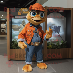 Orange Turtle mascot costume character dressed with a Denim Shirt and Brooches