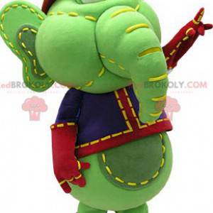 Green and yellow elephant mascot in blue and red outfit -