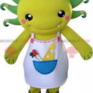 Mascotte creatura gialla e verde con un grembiule -