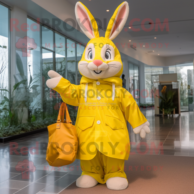 Yellow Wild Rabbit mascot costume character dressed with a Raincoat and Tote bags