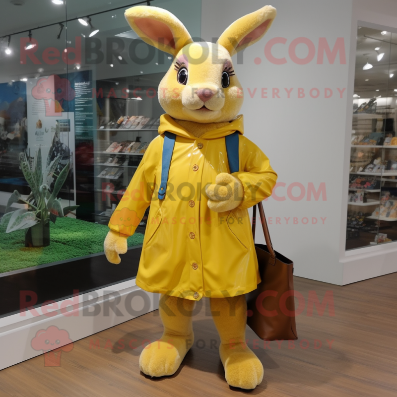 Yellow Wild Rabbit mascot costume character dressed with a Raincoat and Tote bags