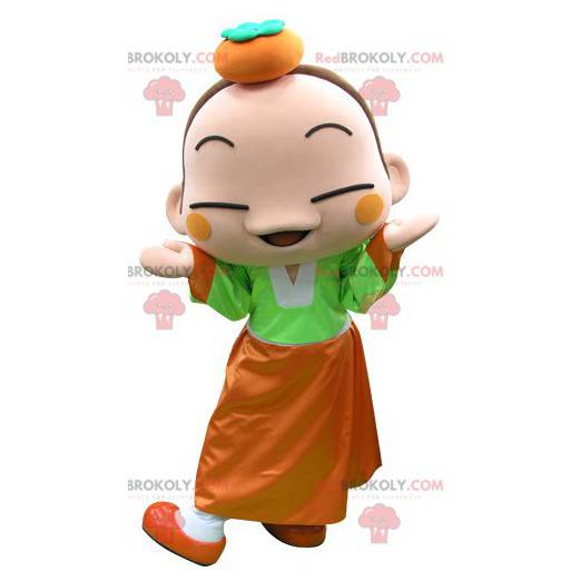 Colorful girl mascot with an orange on her head - Redbrokoly.com