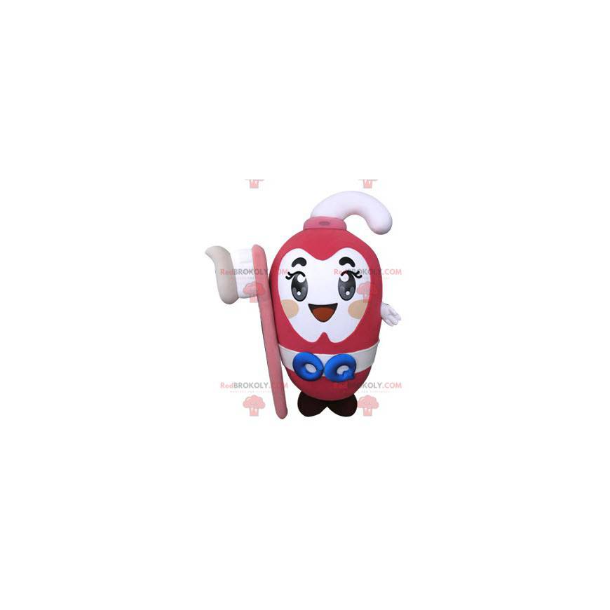 Mascote da pasta de dente rosa segurando uma escova de dente -