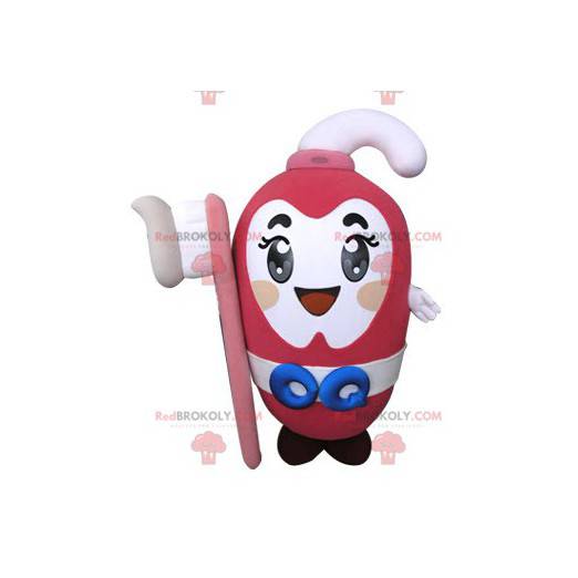 Mascote da pasta de dente rosa segurando uma escova de dente -