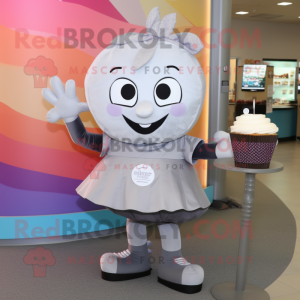 Silver Cupcake mascot costume character dressed with a Yoga Pants and Messenger bags