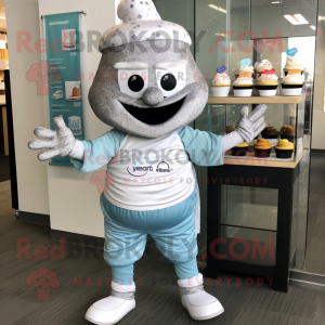 Silver Cupcake mascot costume character dressed with a Yoga Pants and Messenger bags