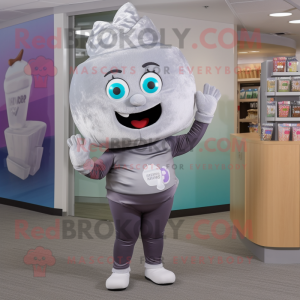 Silver Cupcake mascot costume character dressed with a Yoga Pants and Messenger bags