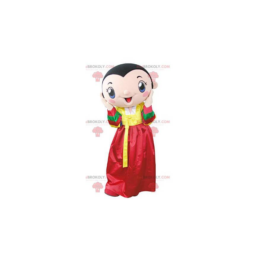 Mascotte de femme brune portant une robe jaune et rouge -