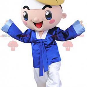 Smiling boy mascot dressed in traditional attire -