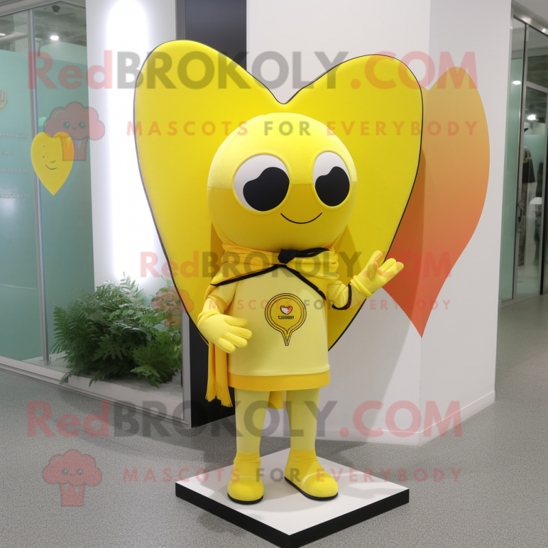 Lemon Yellow Arrow Of Love mascot costume character dressed with a Rash Guard and Shawls Lemon Yellow Arrow Of Love mascot costume character dressed with a Rash Guard and Shawls