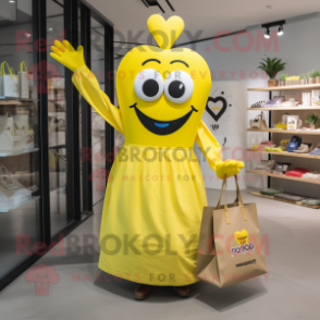 Yellow Heart mascot costume character dressed with a Maxi Skirt and Tote bags