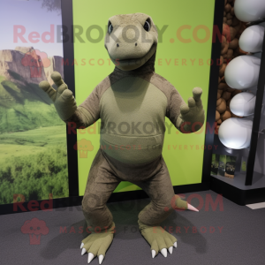 Olive Komodo Dragon mascot costume character dressed with a Yoga Pants and Gloves