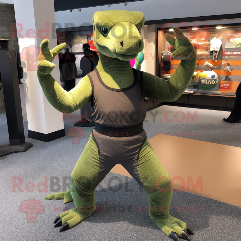 Olive Komodo Dragon mascot costume character dressed with a Yoga Pants and Gloves Olive Komodo Dragon mascot costume character dressed with a Yoga Pants and Gloves