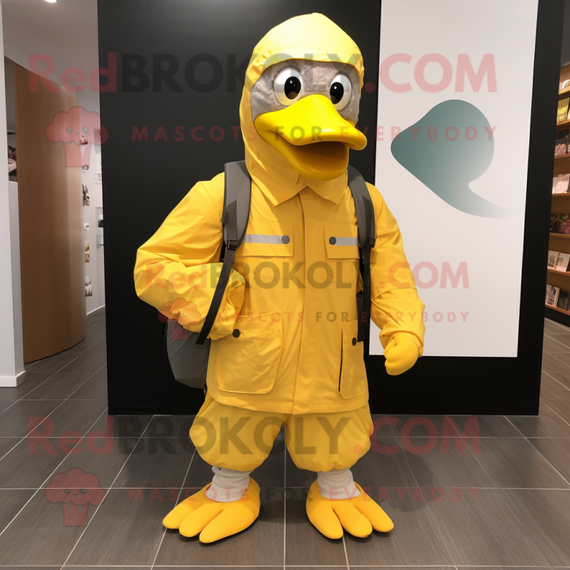 Yellow Albatross mascot costume character dressed with a Windbreaker and Backpacks