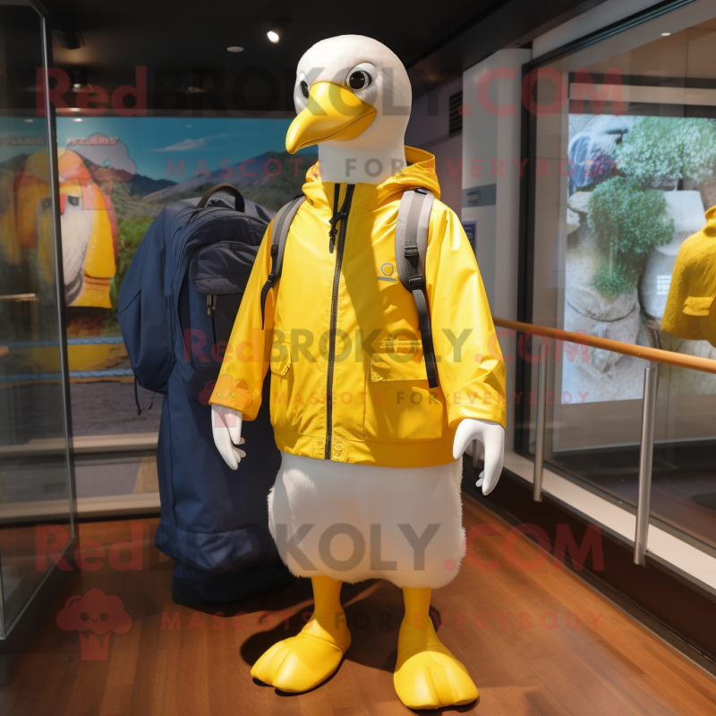 Yellow Albatross mascot costume character dressed with a Windbreaker and Backpacks Yellow Albatross mascot costume character dressed with a Windbreaker and Backpacks