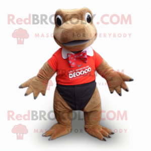 Red Komodo Dragon mascot costume character dressed with a Board Shorts and Bow ties