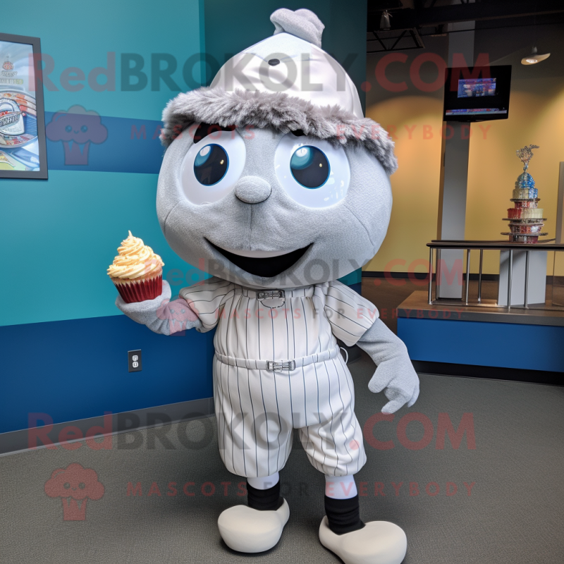 Silver Cupcake mascot costume character dressed with a Baseball Tee and Tie pins