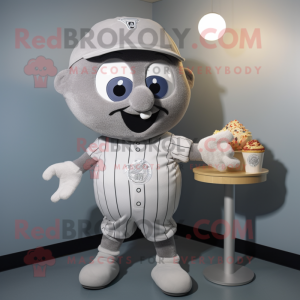 Silver Cupcake mascot costume character dressed with a Baseball Tee and Tie pins