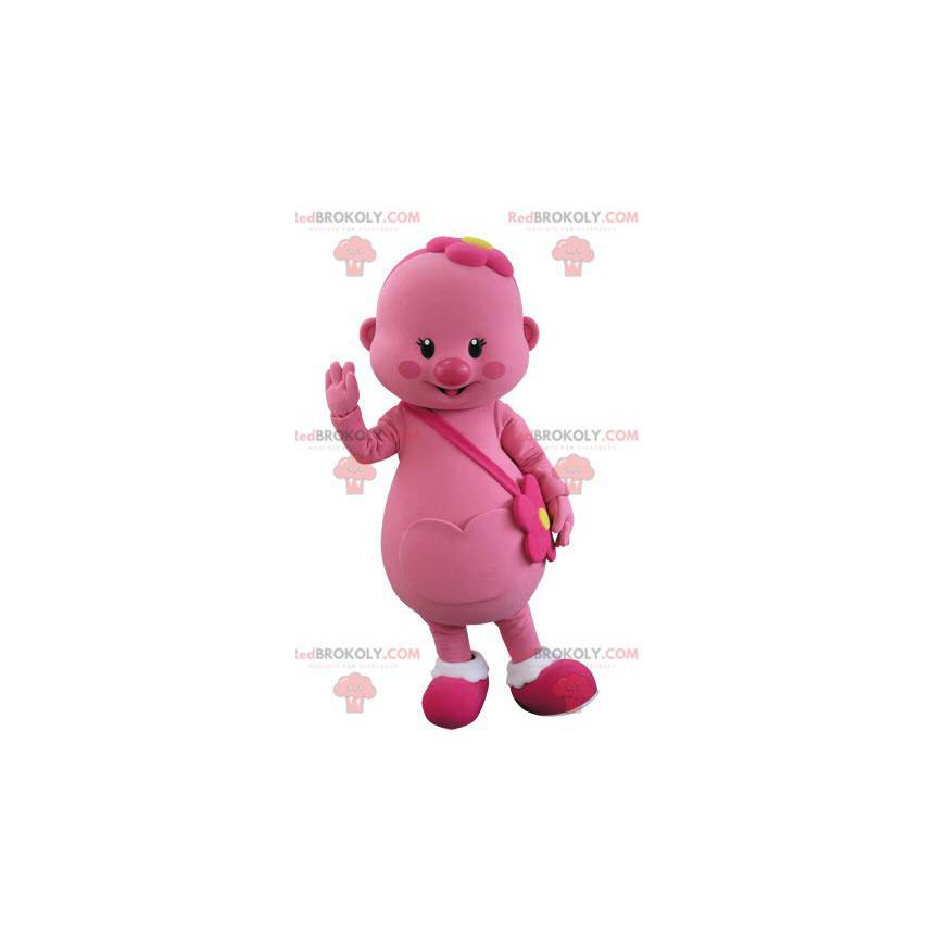 Mascotte de bonhomme rose avec une fleur sur la tête -