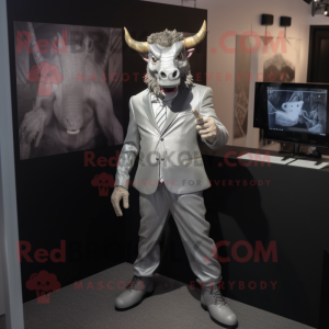 Silver Minotaur mascot costume character dressed with a Suit Jacket and Lapel pins