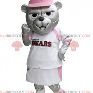Graues Bärenmaskottchen im rosa und weißen Tennisoutfit -