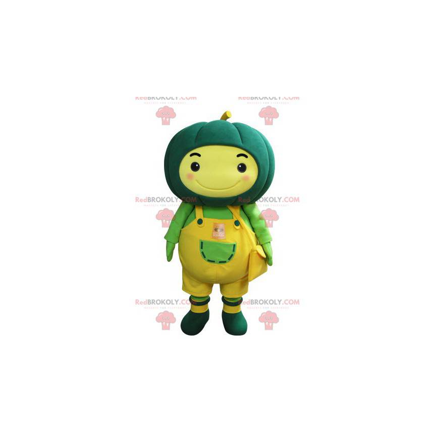 Mascota de muñeco de nieve amarillo con una calabaza verde en